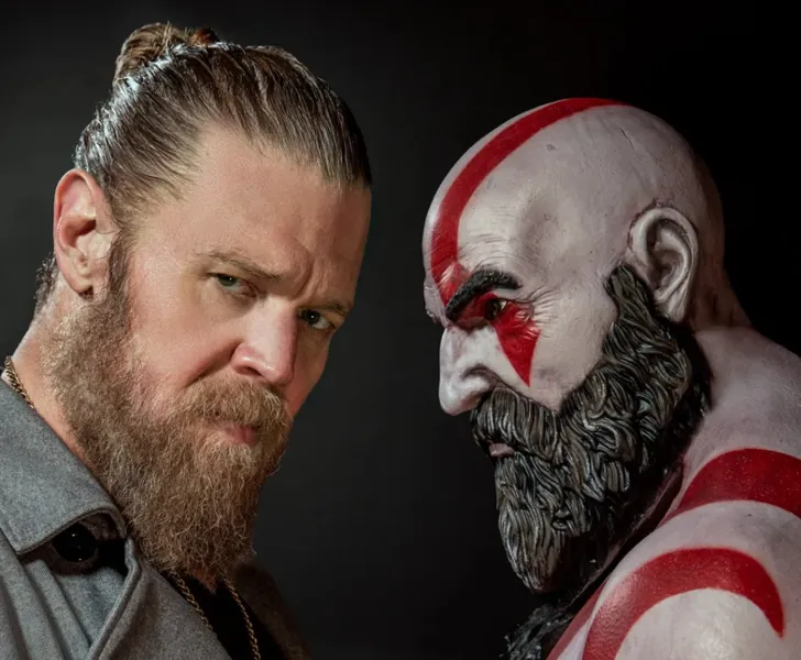 Ryan Hurst stands with a statue of Kratos